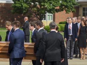 Fred and Cindy Warmbier watch as their son Otto, is placed in a hearse after his funeral, Thursday, June 22, 2017, in Wyoming, Ohio. Otto Warmbier, a 22-year-old University of Virginia student who was sentenced in March 2016 to 15 years in prison with hard labor in North Korea, died this week, days after returning to the United States. (AP Photo/Bryan Woolston)