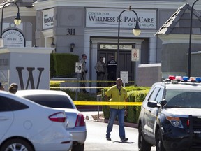 Las Vegas police investigate a shooting at a pain-management clinic in Las Vegas, Thursday, June 29, 2017.  A patient denied a same-day appointment at the clinic in Las Vegas shot and injured two employees Thursday before fatally shooting himself, police said. (Richard Brian/Las Vegas Review-Journal via AP)