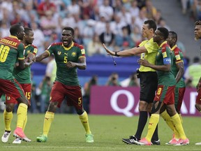 Cameroon players protest with referee Wilmar Roldan during the Confederations Cup, Group B soccer match between Germany and Cameroon, at the Fisht Stadium in Sochi, Russia, Sunday, June 25, 2017. (AP Photo/Thanassis Stavrakis)