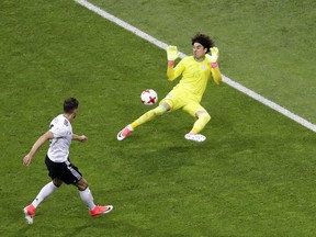 Mexico goalkeeper Guillermo Ochoa fails to save the ball as Germany's Leon Goretzka, left, scores his side's second goal during the Confederations Cup, semifinal soccer match between Germany and Mexico, at the Fisht Stadium in Sochi, Russia, Thursday, June 29, 2017. (AP Photo/Sergei Grits)