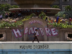Anti-government protesters begin gathering at Altamira Plaza, defaced with messages that read in Spanish; "We're hungry. Maduro Dictator," in Caracas, Venezuela, Monday, June 26, 2017. More than 70 people have been killed during almost 90 days of protests seeking President Nicolas Maduro's removal. (AP Photo/Fernando Llano)