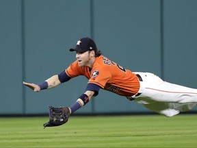 Houston Astros right fielder Josh Reddick dives while trying to catch a double by New York Yankees' Brett Gardner during the third inning of a baseball game Friday, June 30, 2017, in Houston. (AP Photo/David J. Phillip)