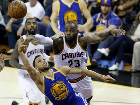 Golden State Warriors guard Stephen Curry shoots in front of Cleveland Cavaliers forward LeBron James  during the second half of Game 3 in Cleveland on Wednesday.