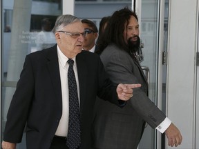 Former Maricopa County Sheriff Joe Arpaio, left, leaves U.S. District Court on the first day of his contempt-of-court trial with attorney Mark Goldman, right, Monday, June 26, 2017, in Phoenix. (AP Photo/Ross D. Franklin)