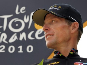 FILE- In this  July 25, 2010, file photo, Lance Armstrong, of the United States, looks back on the podium after the 20th and last stage of the Tour de France cycling race in Paris. Armstrong's $100 million civil fraud trial is months away, yet his fight with the government and former teammate-turned-rival Floyd Landis is heating up. The trial is scheduled for November in federal court in Washington D.C., and lawyers for both sides recently filed a series of motions asking U.S. District Judge Christopher Cooper to exclude some key evidence. (AP Photo/Bas Czerwinski, File)