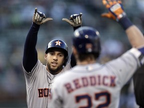Houston Astros' George Springer, left, celebrates with Josh Reddick after hitting a home run off Oakland Athletics' Sonny Gray during the first inning of a baseball game Tuesday, June 20, 2017, in Oakland, Calif. (AP Photo/Ben Margot)