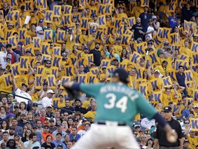 Fans hold "K" cards, designating a strikeout, as Seattle Mariners starting pitcher Felix Hernandez throws against the Houston Astros during the second inning of a baseball game Friday, June 23, 2017, in Seattle. (AP Photo/Elaine Thompson)