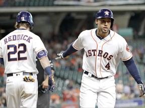 Houston Astros' George Springer (4) celebrates with Josh Reddick (22) after hitting a home run during the first inning of a baseball game against the Oakland Athletics, Wednesday, June 28, 2017, in Houston. (AP Photo/David J. Phillip)