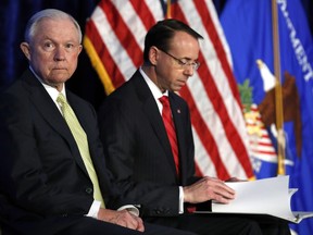 Attorney General Jeff Sessions, left, and Deputy Attorney General Rod Rosenstein take their seats at the Justice Department's National Summit on Crime Reduction and Public Safety, in Bethesda, Md., on Tuesday, June 20, 2017. (AP Photo/Jacquelyn Martin)