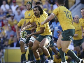 Karmichael Hunt of Australia prepares a pass during an international rugby match between Australia and Italy in Brisbane, Australia, Saturday, June 24, 2017. (AP Photo/Tertius Pickard)