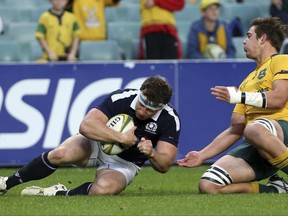 Scotland's Hamish Watson, left, scores a try in front of Australia's Richard Hardwick during their rugby union test match in Sydney, Saturday, June 17, 2017. (AP Photo/Rick Rycroft)