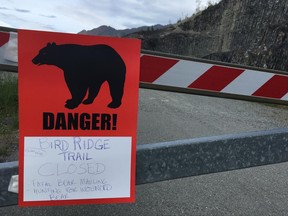 A sign warns people that the trail head is closed on Monday, June 19, 2017, after a fatal bear mauling at Bird Ridge Trail in Anchorage, Alaska. Authorities say a black bear killed a 16-year-old runner while he was competing in an Alaska race on Sunday. (AP Photo/Mark Thiessen)