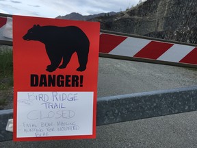 A sign warns people that the trail head is closed on Monday, June 19, 2017, after a fatal bear mauling at Bird Ridge Trail in Anchorage, Alaska.