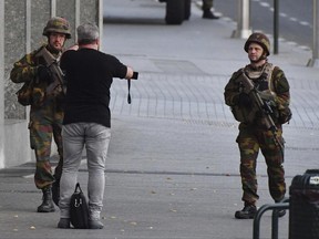 Belgian Army soldiers approaches a man outside Central Station after a reported explosion in Brussels on Tuesday, June 20, 2017. Belgian media are reporting that explosion-like noises have been heard at a Brussels train station, prompting the evacuation of a main square. (AP Photo/Geert Vanden Wijngaert)
