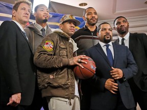 FILE - In this Jan. 11, 2017, file photo, entertainment executive Jeff Kwatinetz, far left, and Ice Cube, second from right, pose with former NBA players Kenyon Martin, second from left, Allen Iverson, third from left, Rashard Lewis, third from right, and Roger Mason, far right, after a press conference announcing the launch of BIG3, a new 3-on-3 professional basketball league, in New York. For his league of former NBA players that debuts Sunday, actor-entertainer Ice Cube insisted the competition be serious, a proper representation of a form of basketball that's so popular that it's ticketed for the next Olympics. (AP Photo/Bebeto Matthews, File)