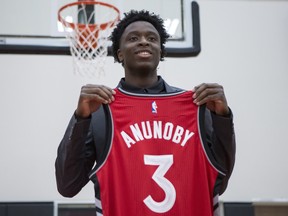 Toronto Raptors 2017 first round draft pick OG Anunoby holds a jersey as he poses for a picture after scrumming with journalists during a media availability in Toronto on Friday, June 23, 2017.