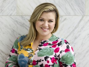 FILE - In this March 4, 2015 file photo, Kelly Clarkson poses for a portrait in New York. After releasing a best-selling children's book, Clarkson is back for an encore. HarperCollins Publishers announced Wednesday, June 28, 2017, that the Grammy winner's "River Rose and the Magical Christmas" is coming out Oct. 24. (Photo by Victoria Will/Invision/AP, File)