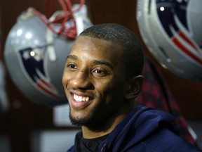 FILE - In this Jan. 26, 2017 file photo, New England Patriots wide receiver Malcolm Mitchell speaks with members of the media in the team's locker room following an NFL football team practice in Foxborough, Mass. Mitchell has a three-book deal with Scholastic, the children's publisher said Thursday, June 23. The books include a newly illustrated edition of his self-published "The Magician's Hat," to come out next May, and two more original works. (AP Photo/Steven Senne, File)