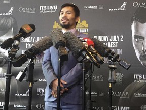 Famed boxer Manny Pacquiao of the Philippines speaks to the media during a press conference with Jeff Horn of Australia in Brisbane, Wednesday, June 28, 2017. Pacquiao, is putting his WBO belt on the line Sunday, July 2, against the 29-year-old Horn. (AP Photo/John Pye)