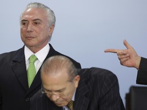 FILE - In this June 5, 2017 file photo, Brazil's President Michel Temer stands behind Chief of Staff Eliseu Padilha during a ceremony marking World Environment Day, at Planalto presidential palace in Brasilia, Brazil. Brazil's attorney general formally accused Temer with corruption on Monday, June 26, 2017, the first time a sitting president in Latin America's largest nation has faced criminal charges. (AP Photo/Eraldo Peres, File)