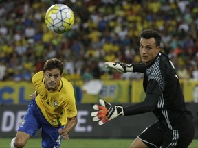 FILE - In this Jan.25, 2017 file photo, Brazil's Rodrigo Caio, left, heads the ball past Colombia's goalkeeper David Gonzalez, failing to score, during a friendly soccer match at Nilton Santos stadium in Rio de Janeiro, Brazil. With more than 200 matches for his club, Caio is keen to go to Europe after a first attempt failed at Valencia, he then failed his medical exams due to a now healed knee injury. (AP Photo/Leo Correa, File)