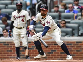 Atlanta Braves' Ender Inciarte bunts the ball in the first inning of a baseball game against the Milwaukee Brewers on Saturday, June 24, 2017, in Atlanta. (AP Photo/Danny Karnik)