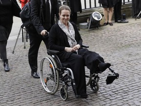 FILE - In this April 5, 2017, file photo, injured U.S. tourist Melissa Cochran, whose husband, Kurt Cohran, was killed in the March 22 London terror attack, arrives for a "Service of Hope" at Westminster Abbey, two weeks after the attack, in London. The life of a Utah man who ran a recording studio at his home before he was killed in a high-profile attack London attack will be celebrated with the local music he loved on Saturday, June 24, 2017. The Islamic State group claimed responsibility for the attack that killed four people and injured scores more, including his Melissa Cochran, of West Bountiful, Utah. (AP Photo/Matt Dunham, File)