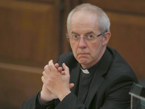 FILE - This is a Monday, Feb. 13, 2017 file photo of the Archbishop of Canterbury Justin Welby as he listens to debate at the General Synod in London. Welby the head of the Church of England  said Thursday June 22, 2017 that the institution "colluded" with and helped to hide the long-term sexual abuse of young men by one of its former bishops. (AP Photo/Alastair Grant/File)
