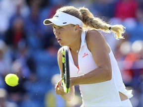 Denmark's Caroline Wozniacki in action against Romania's Simona Halep during the AEGON International tennis tournament, at Devonshire Park, Eastbourne, England, Thursday June 29, 2017. (Gareth Fuller/PA via AP)