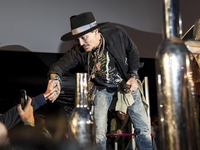 Johnny Depp greets fans at the Glastonbury music festival at Worthy Farm, in Somerset, England, Thursday, June 22, 2017.