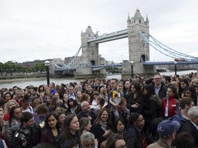 People attend a vigil for victims of Saturday's attack in London Bridge, at Potter's Field Park in London, Monday, June 5, 2017. Police arrested several people and are widening their investigation after a series of attacks described as terrorism killed several people and injured more than 40 others in the heart of London on Saturday. (AP Photo/Tim Ireland)