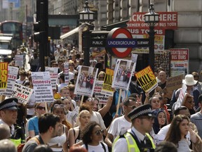 Demonstrators march in central London, many demanding justice justice for the victims of the recent deadly apartment block fire at Grenfell Tower, as they march towards parliament in central London Wednesday June 21, 2017. The mass "Day of Rage" demonstration is timed to coincide with the state opening of parliament Wednesday. (AP Photo / Matt Dunham)