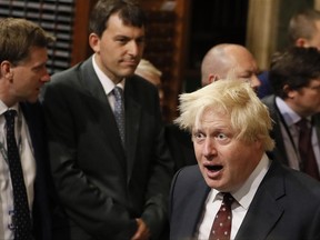 Britain's Foreign Secretary Boris Johnson walks through the House of Commons to attend the state opening of Parliament in London, Wednesday, June 21, 2017. Queen Elizabeth II goes to parliament Wednesday to outline the government's legislative program with far less pageantry than usual in a speech expected to be dominated by Britain's plans for leaving the European Union. (AP Photo/Kirsty Wigglesworth, pool)