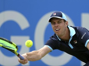 Sam Querrey of the United States returns a ball,  during his match against Luxembourg's Gilles Muller, on day five of the Queen's Club tennis tournament in London, Friday June 23, 2017. (Steven Paston/PA via AP)