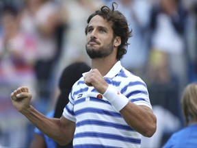 Spain's Feliciano Lopez celebrates winning his match against Czech Republic's Tomas Berdych on day five of the Queen's Club tennis tournament in London, Friday June 23, 2017. (Steven Paston/PA via AP)