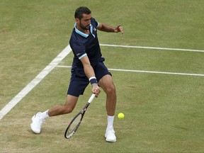 Croatia's Marin Cilic in action against Spain's Feliciano Lopez during their final match at The Queen's Club tennis tournament in London, Sunday June 25, 2017. (Steven Paston/PA via AP)