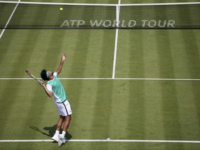 France's Jo-Wilfried Tsonga serves to France's Adrian Mannarino on day one of the Queen's Championships London, England, Monday June 19, 2017. (Steven Paston/PA via AP)