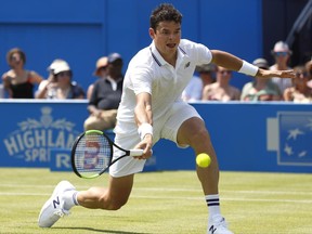 Milos Raonic of Canada plays a return to Thanasi Kokkinakis of Australia during day two of the Queen's Club tennis tournament in London, Tuesday, June 20, 2017.