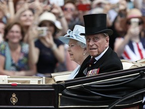 Britain's Queen Elizabeth II and Prince Philip return to Buckingham Palace in a carriage, after attending the annual Trooping the Colour Ceremony in London June 17, 2017.
