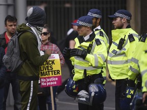 Campaigners face-off with police as they protest over the death of 25-year old young father Edir Frederico Da Costa, who died on June 21 six days after he was detained by police, in London Sunday June 25, 2017.  Protesters allege Edir Frederico Da Costa was beaten and died of his wounds after being stopped in a car by Police officers in east London, while pathologists have said there were no injuries to suggest severe force was used by police. (Lauren Hurley/PA via AP)