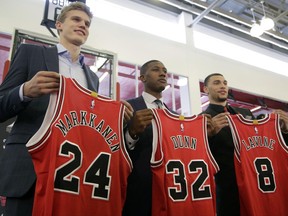 Chicago Bulls seventh overall draft pick Lauri Markkanen, left, Kris Dunn, center, and Zach Levine, pose for a photo at the NBA basketball team's training facility, Tuesday, June 27, 2017, in Chicago. Dunn and Levine was acquired by the Bulls from the Minnesota Timberwolves in exchange for Jimmy Butler and this year's No. 16th overall pick, Justin Patton. (AP Photo/G-Jun Yam)