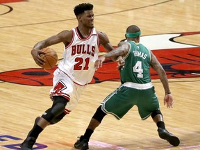FILE - In this April 23, 2017, file photo, Chicago Bulls' Jimmy Butler (21) is fouled by Boston Celtics' Isaiah Thomas during the second half in Game 4 of an NBA basketball first-round playoff series in Chicago. Two people with knowledge of the situation tell The Associated Press that the Bulls have traded three-time All-Star Butler and the 16th overall pick to the Minnesota Timberwolves for Zach LaVine, Kris Dunn and the No. 7 overall draft pick. The people spoke to The AP on condition of anonymity because the deal has not been officially announced. (AP Photo/Charles Rex Arbogast, File)