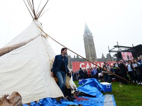 Prime Minister Justin Trudeau leaves a Teepee on Parliament Hill in Ottawa on Friday, June 30, 2017. Trudeau had a brief meeting this morning with indigenous activists who have set up a demonstration teepee on Parliament Hill ahead of Canada Day celebrations. THE CANADIAN PRESS/Sean Kilpatrick