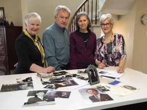 Senator Paul Yuzyk's children Vera Yuzyk, from right, Evangeline Duravetz, Ted Yuzyk, and Vicki Karpiak look at photos of their father in Ottawa on Tuesday, April 25, 2017. THE CANADIAN PRESS/Sean Kilpatrick