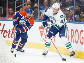 Vancouver Canucks forward Brendan Gaunce (right) controls the puck in an Oct. 8, 2016 pre-season game against the Edmonton Oilers.