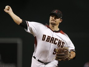Arizona Diamondbacks' Zack Godley throws a pitch against the St. Louis Cardinals during the first inning of a baseball game, Wednesday, June 28, 2017, in Phoenix. (AP Photo/Ross D. Franklin)