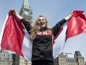 Canadian athlete Rosie MacLennan holds a Canadian flag after being named as the flag bearer for the Summer Olympics Thursday July 21, 2016 in Ottawa.