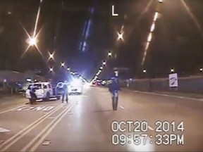 In this Oct. 20, 2014 file image taken from dash-cam video provided by the Chicago Police Department, Laquan McDonald, right, walks down the street moments before being fatally shot by Chicago Police officer Jason Van Dyke in Chicago