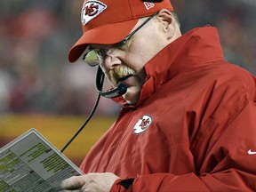 FILE - In this Jan. 15, 2017, file photo, Kansas City Chiefs head coach Andy Reid looks over his play card during the first half of an NFL divisional playoff football game against the Pittsburgh Steelers in Kansas City, Mo. Reid, who was entering the final year of a five-year deal, has signed a contract extension with the Kansas City Chiefs. The terms of the extension were not announced Thursday, June 22, 2017.  (AP Photo/Ed Zurga, File)