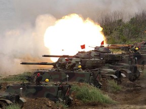 In this Tuesday, May 25, 2017, file photo, a line of U.S. M60A3 Patton tank fire at targets during the annual Han Kuang exercises on the outlying Penghu Island, Taiwan